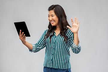 Image showing happy asian woman having video call on tablet pc