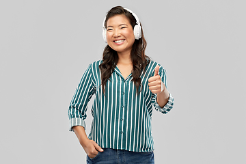 Image showing happy asian woman in headphones showing thumbs up