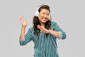 Image showing asian woman in headphones listening to music