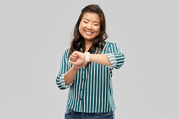 Image showing happy smiling woman with smart watch