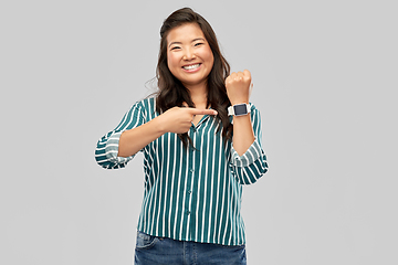 Image showing happy smiling woman with smart watch