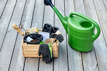 Image showing box with garden tools and watering can in summer