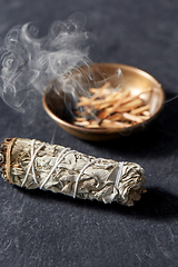 Image showing white sage and cup with smoking matches