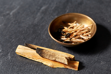 Image showing palo santo sticks and cup with burnt matches