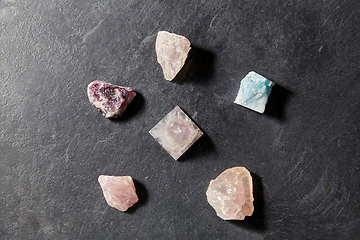 Image showing quartz crystal pyramid and gem stones on slate