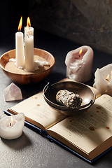 Image showing magic book, sage, burning candles and ritual staff