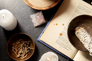 Image showing magic book, sage, burning candles and ritual staff