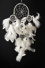 Image showing white dreamcatcher on black background