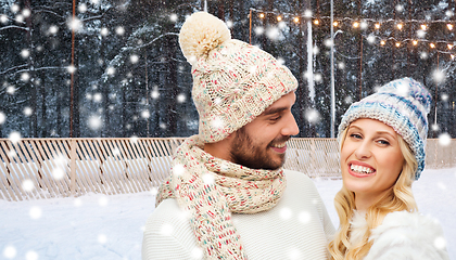 Image showing happy couple over ice skating rink in winter