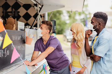 Image showing customers in masks at food truck