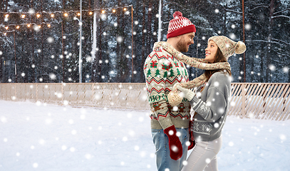 Image showing couple in ugly sweaters on christmas ice rink