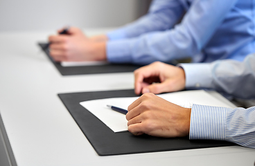 Image showing close up of businessman with papers at office