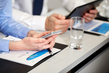 Image showing close up of hands with smartphone at office