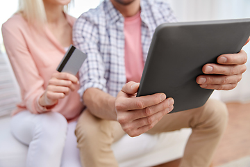 Image showing couple with tablet pc and credit card at home
