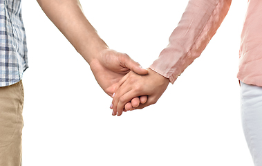 Image showing close up of happy couple holding hands at home