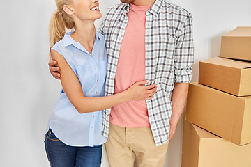 Image showing happy couple with boxes moving to new home