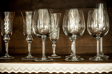 Image showing glasses on the shelf of an old cabinet