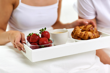 Image showing couple having breakfast in bed at home