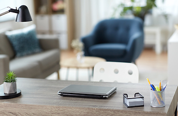 Image showing laptop and stationary on table at home office