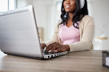 Image showing woman in headphones with laptop working at home