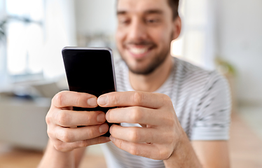 Image showing close up of happy man with smartphone at home