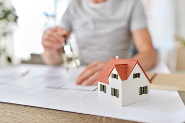 Image showing architect with blueprint working at home office