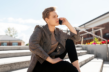 Image showing teenage boy calling on smartphone in city