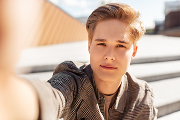 Image showing young man or teenage boy taking selfie in city