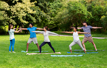 Image showing group of people doing yoga at summer park