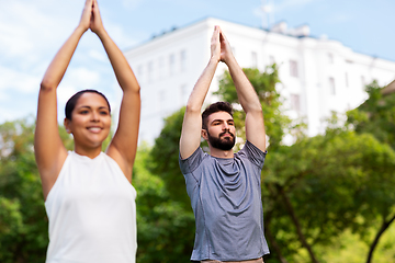 Image showing group of people doing yoga at summer park