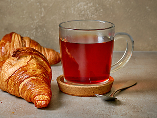 Image showing close up of tea cup and croissants