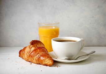 Image showing freshly baked croissant and cup of coffee