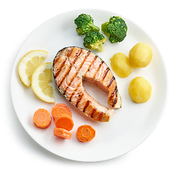 Image showing plate of grilled salmon steak and vegetables