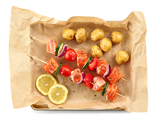 Image showing fresh raw salmon and vegetable skewers and potatoes