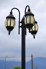 Image showing Vintage street lamp against a cloudy sky