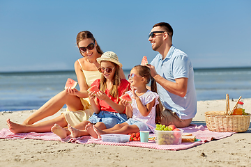 Image showing happy family having picnic on summer beach