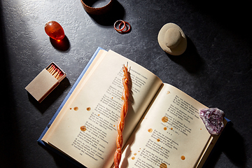 Image showing magic book, wax candle, matches and gem stones