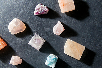 Image showing quartz crystal pyramid and gem stones on slate