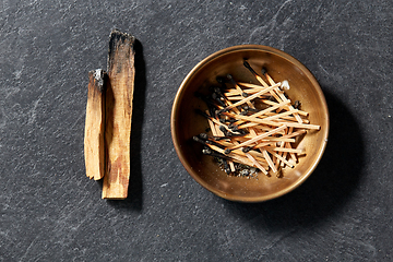 Image showing palo santo sticks and cup with burnt matches