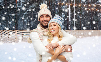 Image showing couple hugging over ice skating rink in winter