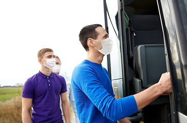 Image showing group of passengers in masks boarding travel bus