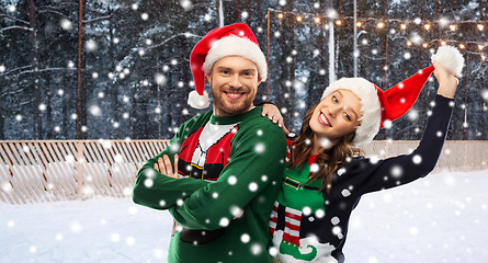 Image showing happy couple in ugly sweaters on christmas