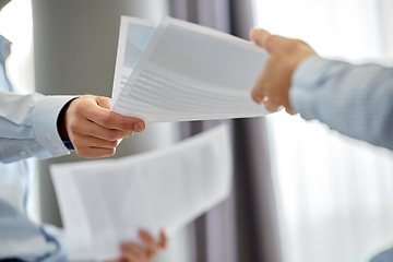 Image showing close up of business team with papers at office