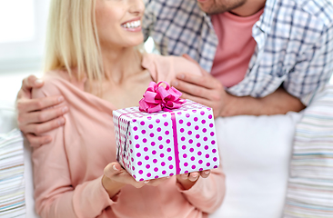 Image showing happy couple with gift box at home