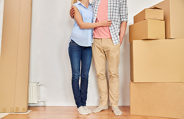 Image showing happy couple with boxes moving to new home