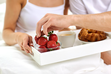 Image showing couple having breakfast in bed at home