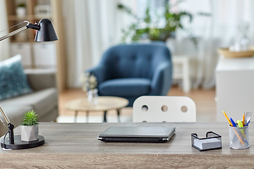 Image showing laptop and stationary on table at home office