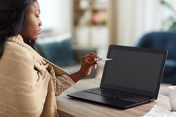 Image showing sick woman having video call on laptop at home