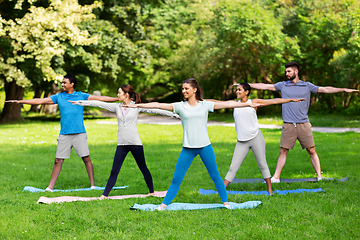 Image showing group of people doing yoga at summer park