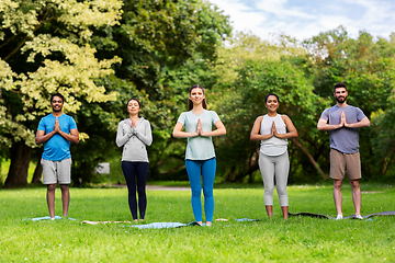 Image showing group of people doing yoga at summer park